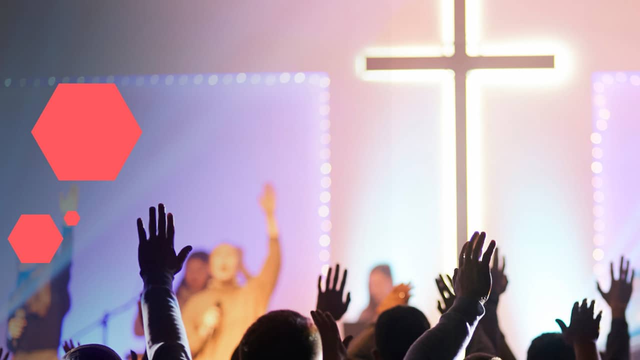 hands raised in worship with cross in background