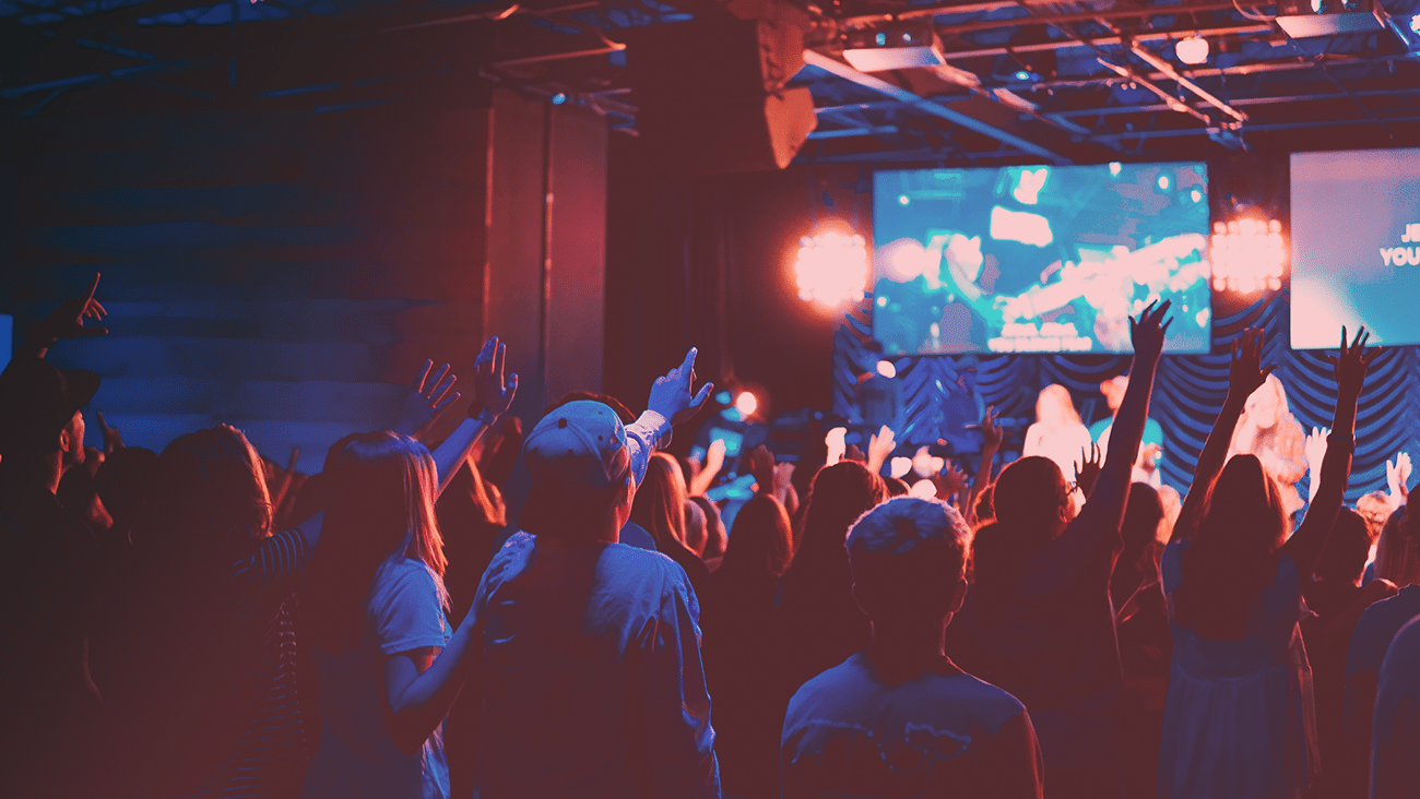 people worshipping in a church auditorium