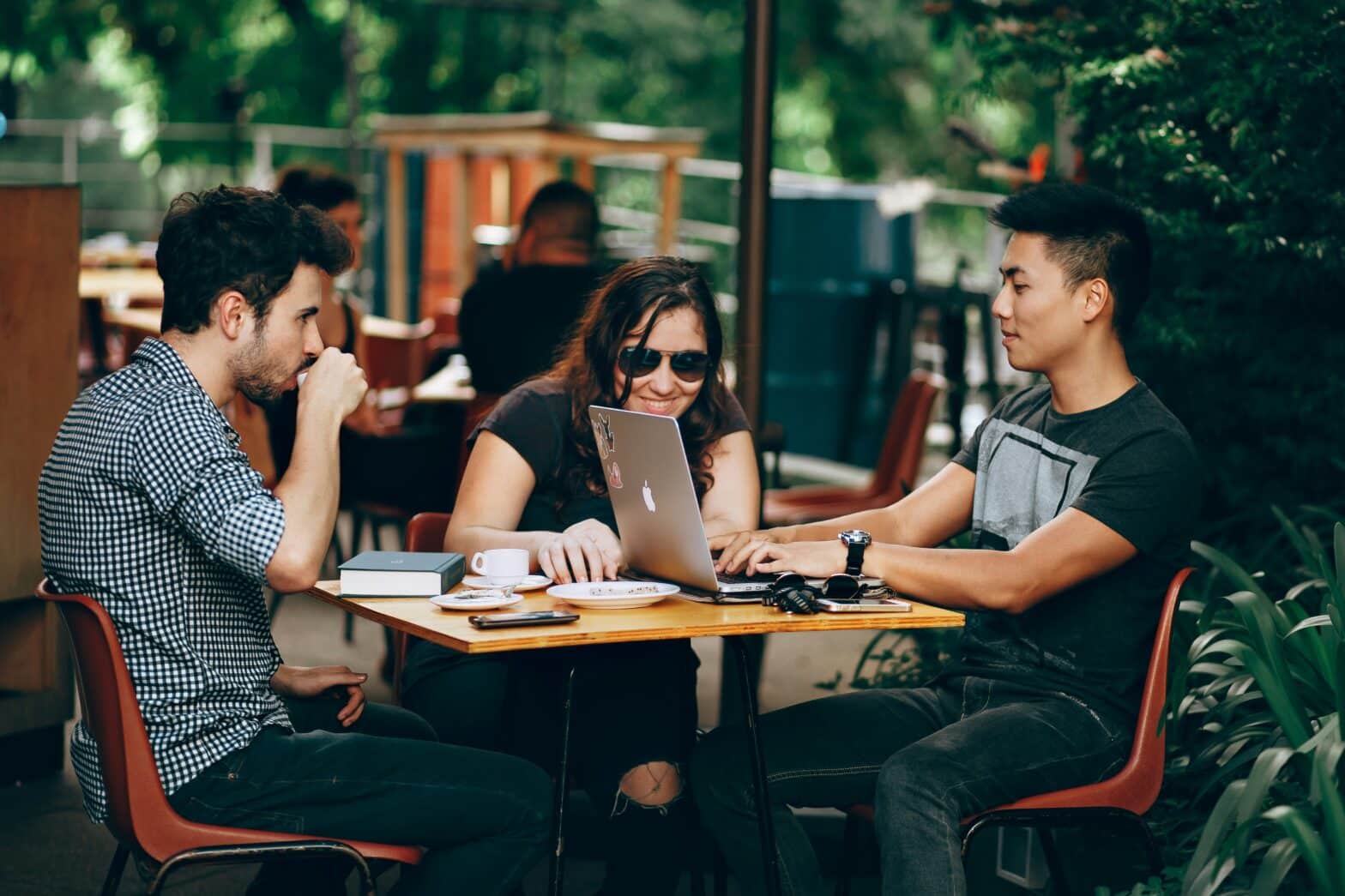 friends sitting around a table discussing how to securely store video files